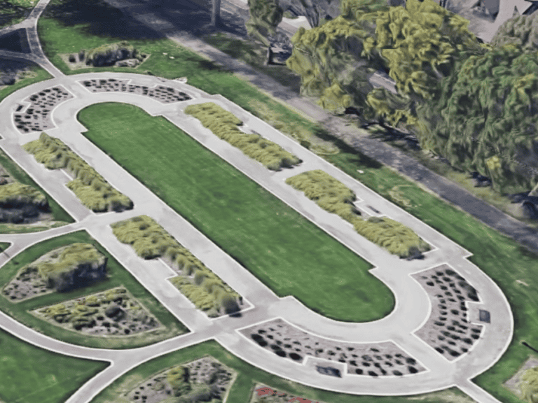 A lush petanque court with surrounding greenery and seating areas for players and spectators.